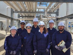 Group of professionals in FRC and Safety PPE at a pipe facility